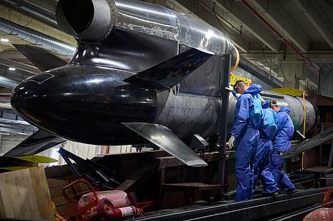 Workers inspect a Flamingo cruise missile at Fire Point's secret factory in Ukraine on Monday, Aug. 18, 2025.