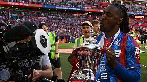 Crystal Palace's English midfielder Eberechi Eze poses with the trophy after the English FA Cup final football match between Crystal Palace and Manchester City at Wembley stadium in London, on May 17, 2025. 