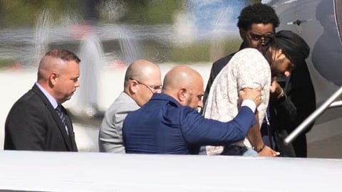 Harjinder Singh is escorted onto an airplane by Florida Lt. Gov. Jay Collins and law enforcement on Thursday in Stockton