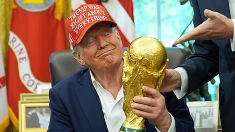 President Donald Trump holds the FIFA World Cup Winners Trophy during an announcement in the Oval Office of the White House, Friday, Aug. 22, 2025, in Washington.