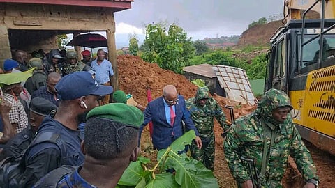 Guinean Prime Minister Amadou Oury Bah, center, visits the site of a landslide caused by heavy rains in Manéah, Guinea, Wednesday, Aug. 21, 2025.