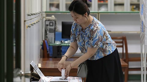 A woman casts her ballot at a polling station in Taipei, Taiwan, on Saturday, Aug. 23, 2025, during the vote which includes a referendum on restarting the Maanshan nuclear power plant.