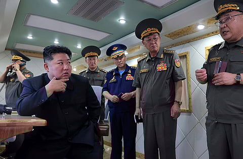 In this photo provided Sunday, Aug. 24, 2025, by the North Korean government, North Korean leader Kim Jong Un, left, supervises the test-firing of two types of new anti-air missiles at undisclosed location, North Korea on Aug. 23, 2025. 