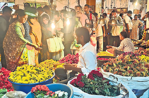 People make a beeline to purchase flowers ahead of Ganesha Chaturthi at KR Market on Sunday.
