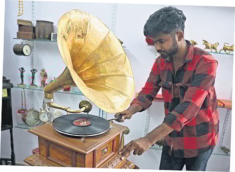 A man works on a gramophone at his shop in the Old City of Hyderabad 