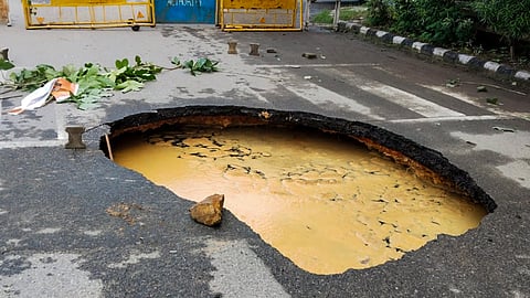 A portion of a road caved in after heavy rainfall, at Dwarka in New Delhi, Sunday, Aug. 24, 2025.