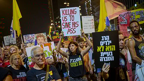 People take part in a protest demanding the end of the war and immediate release of hostages held by Hamas in the Gaza Strip and against Prime Minister Benjamin Netanyahu's government in Tel Aviv, Israel, Saturday, Aug. 23, 2025.