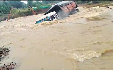 The truck is seen being swept away in the floodwater at Safei nullah.