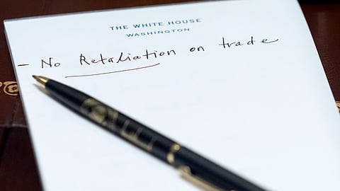 A note reading "No retaliation on trade" written by US Treasury Secretary Scott Bessent is seen on a notepad during a cabinet meeting with President Donald Trump at the White House, Tuesday, Aug. 26, 2025, in Washington.