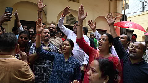People gather outside the residence of AAP leader Saurabh Bharadwaj amid a raid being conducted against him by the Enforcement Directorate.