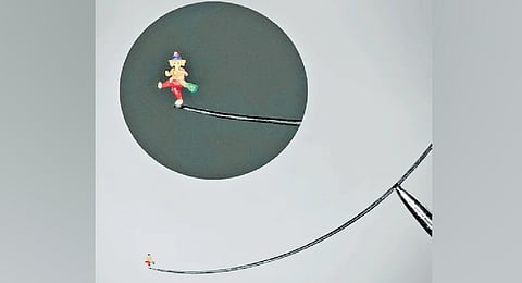 The sculpture of Lord Ganesha, dancing on the tip of an eyelash, as seen through a microscope.