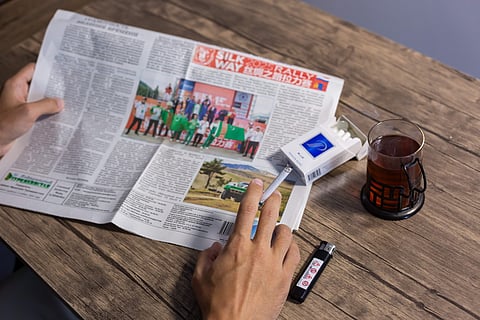 A man smokes in his appartment on July 27, 2025, as Turkmenistan imposes smoking restrictions.