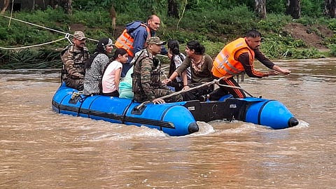 Indian army rescuing stranded people to safer areas.