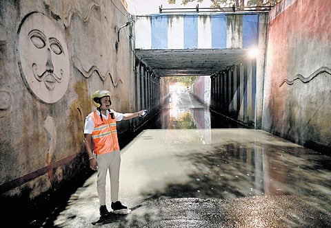 A traffic policeman keeps vigil at KR Circle underpass, which was flooded due to heavy rain, in Bengaluru on Thursday 