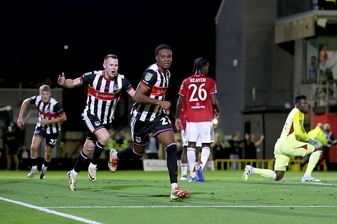 Grimsby Town's Tyrell Warren, center, celebrates scoring their side's second goal during an English League Cup second round soccer match against Manchester United, Wednesday, Aug. 27, 2025.