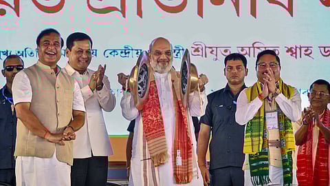 Union Home Minister Amit Shah plays 'Bhor Taal' during the 'NDA Panchayat Pratinidhi Sammelan', in Guwahati.