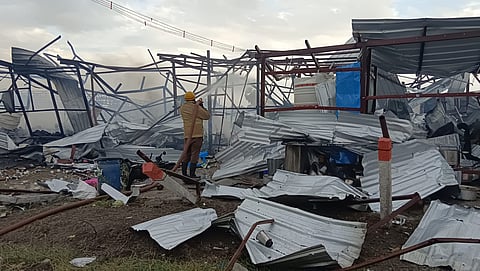 A fire fighter dousing the smoke at the cracker unit in Thoothukudi
