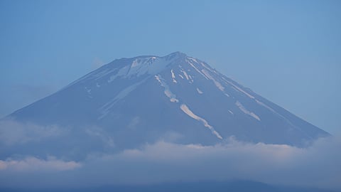 FILE - The top of Mount Fuji is seen in Fujikawaguchiko town, about 110 kilometers (68 miles) west of Tokyo, June 14, 2024
