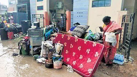 Flood-hit residents clean their homes in GR Colony, Kamareddy on Friday 