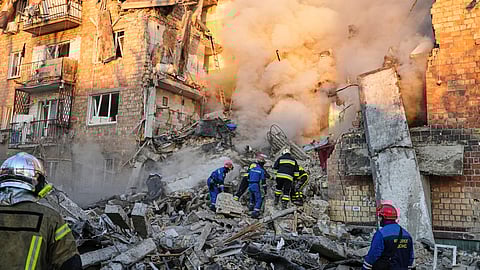 Firefighters work on the site of a burning building after a Russian attack in Kyiv, Ukraine, early Thursday, Aug. 28, 2025.