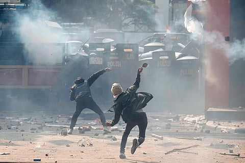 Protesters clash with riot police officers following the death of a delivery rider in clashes between riot police and students protesting against lawmakers' allowances, in Jakarta