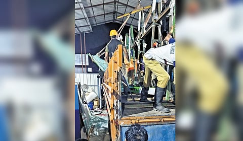 Rescue workers trying to remove glass sheets that toppled onto Anil.