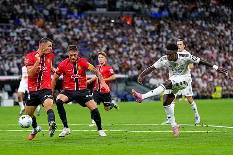 Real Madrid's Vinicius Junior, right, scores his side's second goal during the Spanish La Liga soccer match between Real Madrid and Mallorca in Madrid, Aug. 30, 2025.