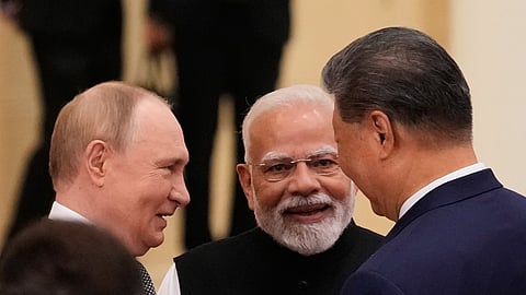 Russian President Vladimir Putin, Indian Prime Minister Narendra Modi and Chinese President Xi Jinping talk at the Shanghai Cooperation Organization (SCO) summit in Tianjin.
