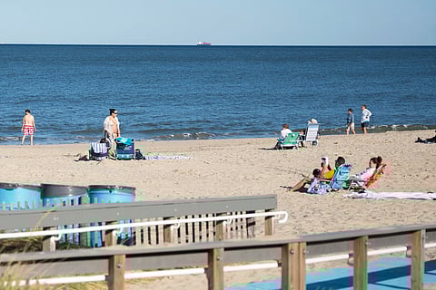 People relax at Rehoboth Beach, Del., on Wednesday, Aug. 27, 2025