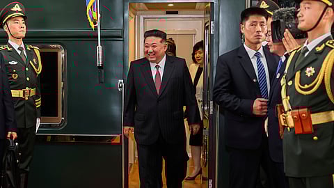 In this photo released by Xinhua News Agency, North Korea leader Kim Jong Un, center, disembarks from a train as he arrives at a railway station, in Beijing, China, Tuesday, Sept. 2, 2025.