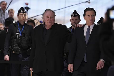 Actor Gerard Depardieu arrives with his lawyer Jeremie Assous, right, to face trial for the alleged sexual assaults of two women on a film set in 2021, Monday, March 24, 2025 in Paris.