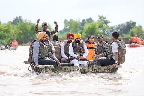 CM Mann touring a flood-affected area by boat (Photo | Special arrangement)