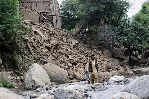 Afghan refugees gather beside trucks loaded with their belongings as they wait their turn to leave for their homeland through a border crossing point which partially opens following the Oct. 19 ceasefire, on the outskirts of Chaman, a border town on the Pakistan-Afghan border, Wednesday, Oct. 29, 2025.