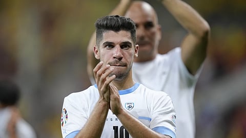 Israel’s Manor Solomon applauds supporters at the end of the Euro 2024 qualifying soccer match between Romania and Israel at the National Arena stadium in Bucharest, Romania, Saturday, Sept. 9, 2023.
