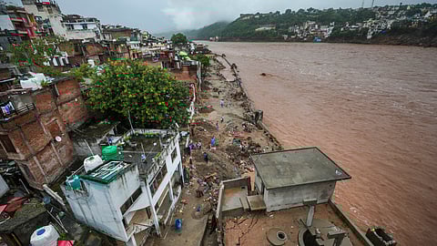The Gujjar nagar area near the Tawi river which continues to flow in spate amid rainfall, in Jammu.
