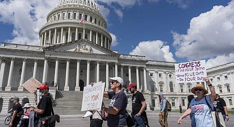 Demonstrators protest the policies of President Donald Trump, the Congress, and the delay in the Epstein investigation as lawmakers return from the August recess, at the Capitol in Washington, Tuesday, Sept. 2, 2025.