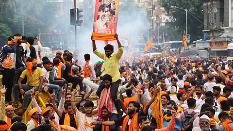Maratha community members celebrate after the Maharashtra government accepted most of activist Manoj Jarange Patil's demands, including granting eligible Marathas Kunbi caste certificates which will make them eligible for reservation benefits available to OBCs, in Mumbai, Tuesday, Sept. 2, 2025.