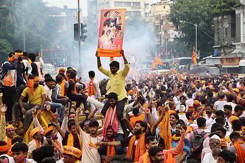 Maratha community members celebrate after the Maharashtra government accepted most of activist Manoj Jarange Patil's demands, including granting eligible Marathas Kunbi caste certificates which will make them eligible for reservation benefits available to OBCs, in Mumbai, Tuesday, Sept. 2, 2025.