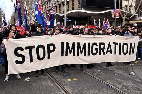 Protesters hold a banner during a "March for Australia" anti-immigration rally in Melbourne on August 31, 2025.
