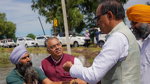 Union Agriculture Minister Shivraj Singh Chouhan meeting a farmer during his visit to flood-hit Punjab (Photo | Special arrangement)