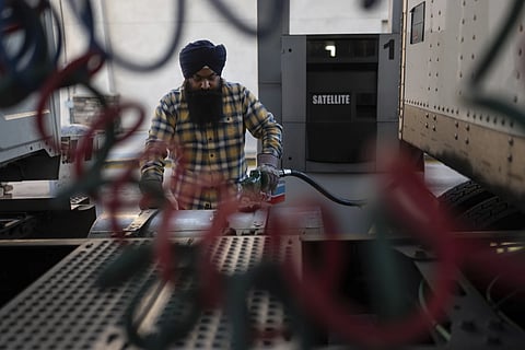 Sikh truck driver Prahb Singh fills up the tank of his truck at a gas station in Fontana, Calif., Wednesday, Sept. 3, 2025.