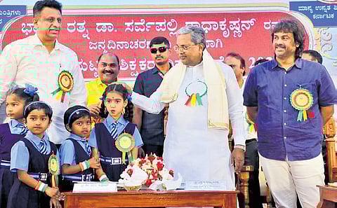 Chief Minister Siddaramaiah with ministers Madhu Bangarappa and MC Sudhakar during a Teachers’ Day programme at Vidhana Soudha on Friday.