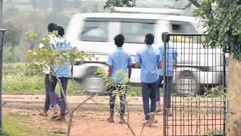 Students of the government school in Hombal cross the highway to attend nature’s call.