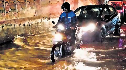 Vehicles move through a waterlogged underpass at Seshadripuram in Bengaluru on Saturday.