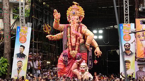 People take part in a procession for immersion of 'Mumbai Cha Raja' idol of Lord Ganesha as part of the Ganesh Chaturthi festival celebrations, in Mumbai, Saturday, Sept. 6, 2025.