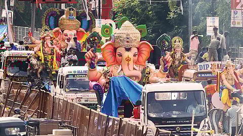Ganesha idol procession in progress on NTR Marg on Sunday.