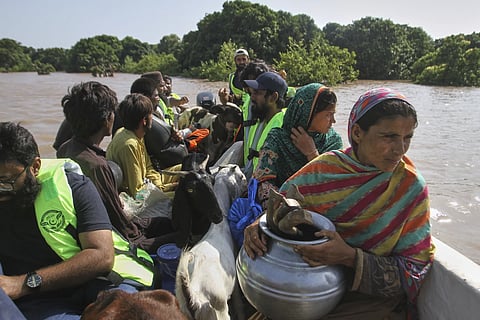 Volunteers evacuate villagers from a flooded area following heavy rains and surging water in rivers, in Muzaffargarh, Pakistan, Thursday, Sept 4, 2025.