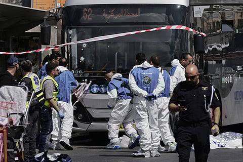 Israeli police and rescue teams inspect the scene of a shooting attack carried out by two Palestinian gunmen, in which several people were killed and others injured at a bus stop in Jerusalem, Monday, Sept. 8, 2025. 