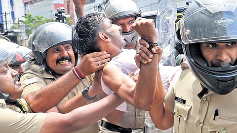 Police remove a Youth Congress worker during a protest demanding action against cops accused in the Kunnamkulam custodial assault, in front of the Secretariat in Thiruvananthapuram on Monday.