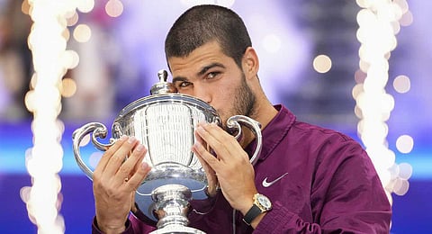Carlos Alcaraz, of Spain, kisses the championship trophy after defeating Jannik Sinner, of Italy, in the men's singles final of the U.S. Open tennis championships, Sunday, Sept. 7, 2025, in New York.